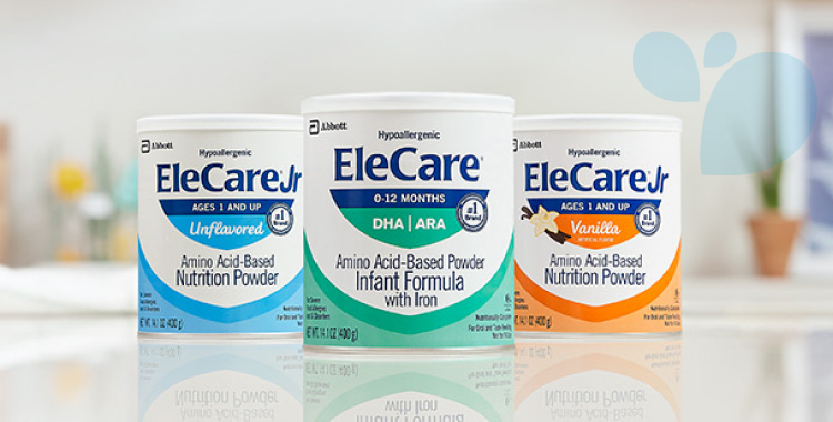 Cans of EleCare Jr Unflavored, EleCare Infant Formula, and EleCare Jr Vanilla sitting on a kitchen counter.